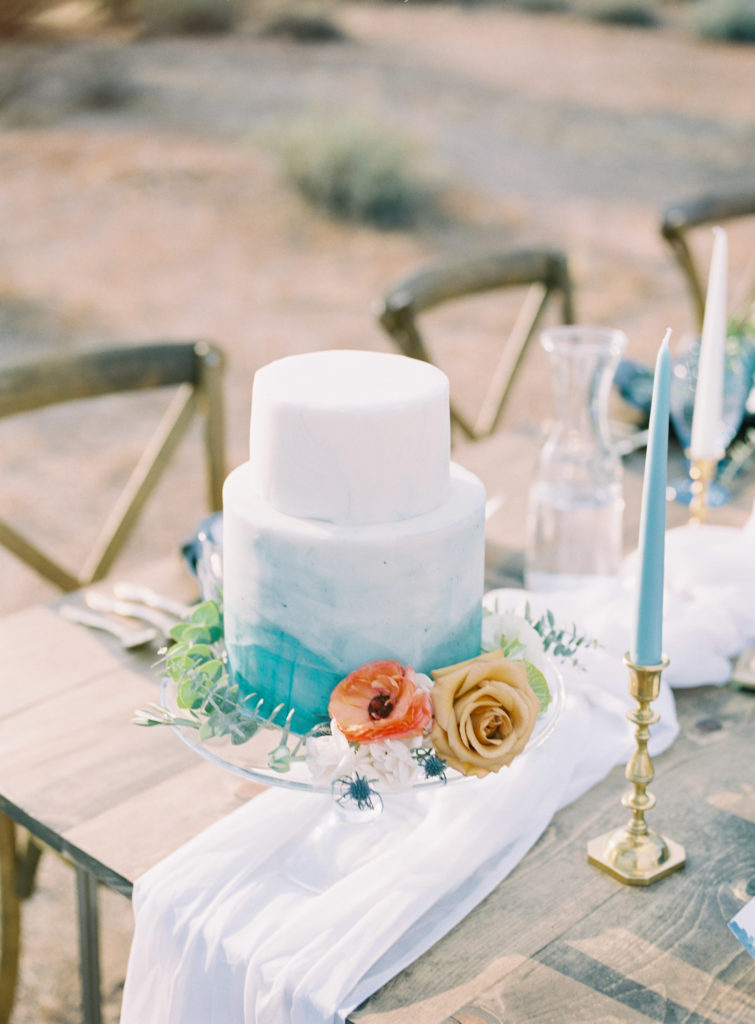 Classic and elegant desert wedding with blue watercolor details. Florals of roses, scabiosa, and blue thistle by Array Design.