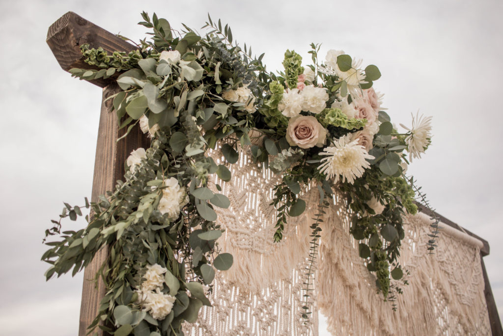 Arch floral at winter neutral palette wedding with taupe and blush accents featuring white flowers with greenery by Array Design, Phoenix, Arizona.