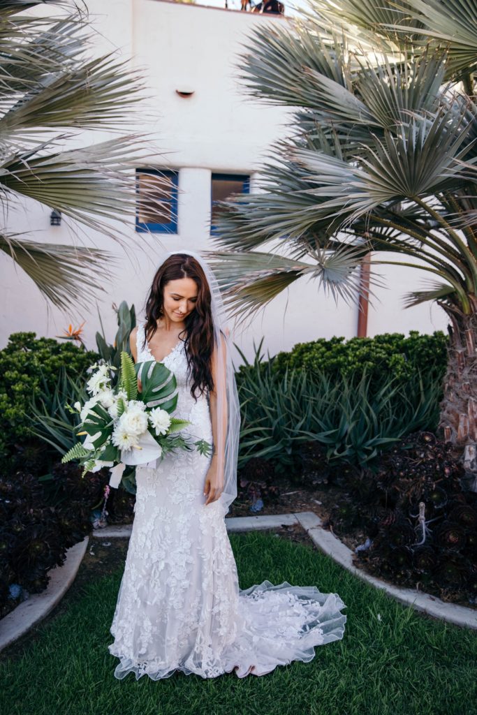 Beautiful tropical California wedding with beach views. Floral designs of neutral palette and Monstera leaves by Array Design, Phoenix, Arizona.