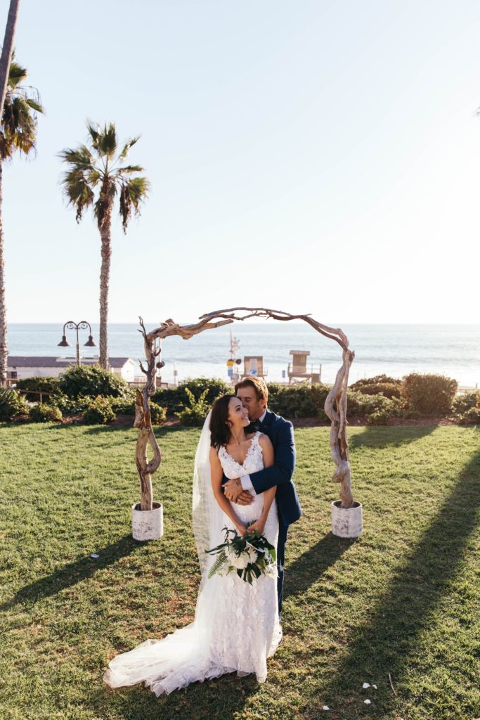Beautiful tropical California wedding with beach views. Floral designs of neutral palette and Monstera leaves by Array Design, Phoenix, Arizona.