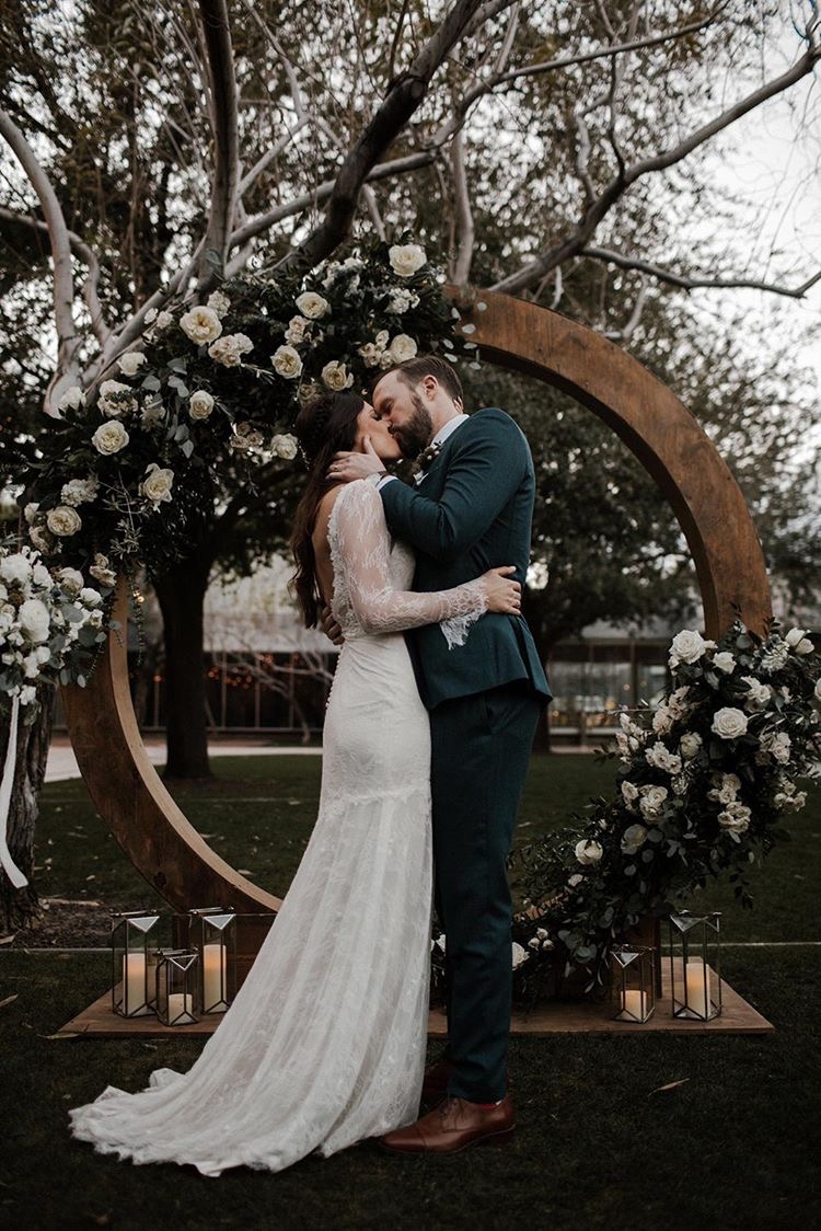 Phoenix Art Museum lawn wedding ceremony with wooden circle arch. Romantic, soft floral by Array Design, Phoenix, Arizona. Photographer: Jamie Allio