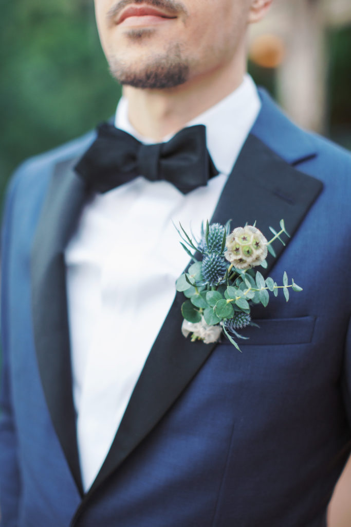 Textured greenery groom boutonniere at Arizona spring wedding featuring whimsical soft palette florals by Array Design, Phoenix, Arizona. Val Vista Lakes venue and Melissa Jill photography.