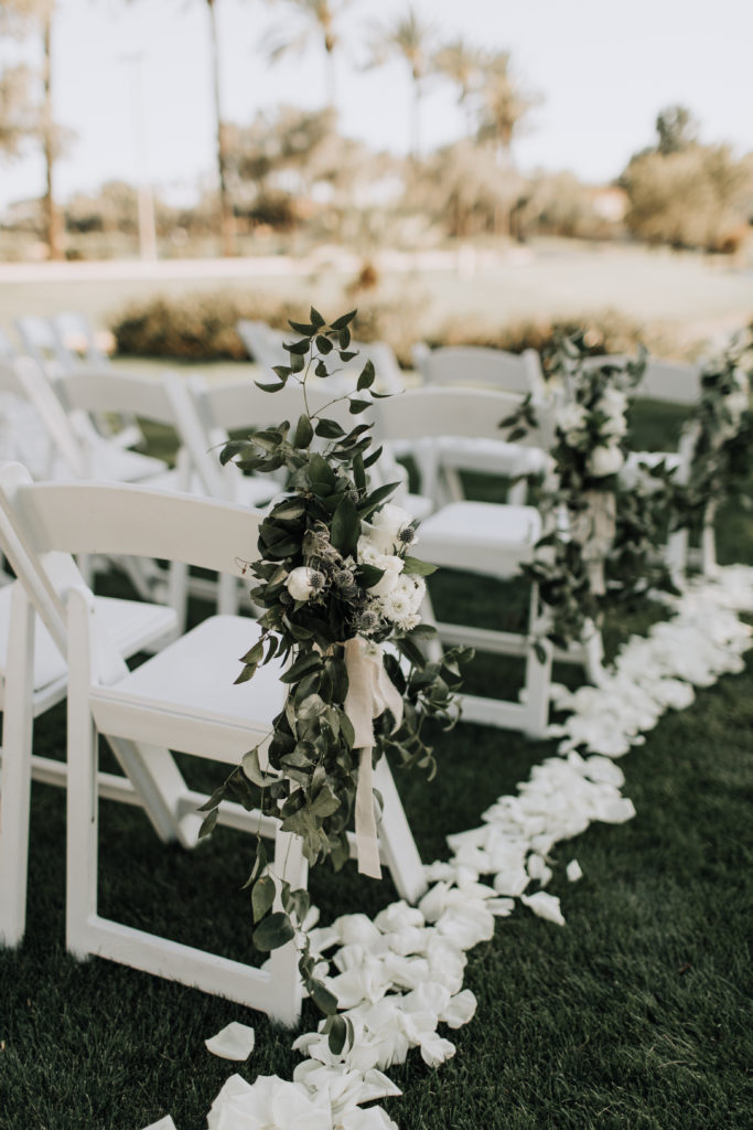 Ceremony aisle rose petals and chair greenery with soft palette floral at a romantic and whimsical styled wedding. Floral by Array Design, Phoenix, Arizona. Photographer: @alexandraloraine