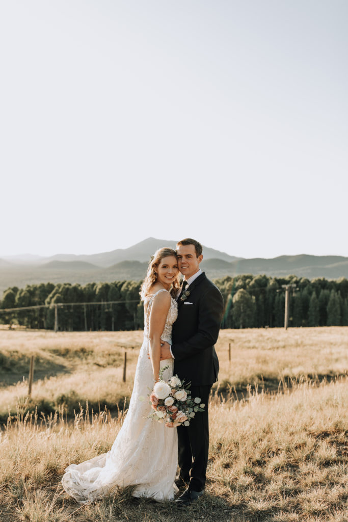 Flagstaff Mountain Wedding - fall outdoor Arizona wedding with wedding flowers in white, mauve and pink with greenery. Photos by Alexandra Loraine.