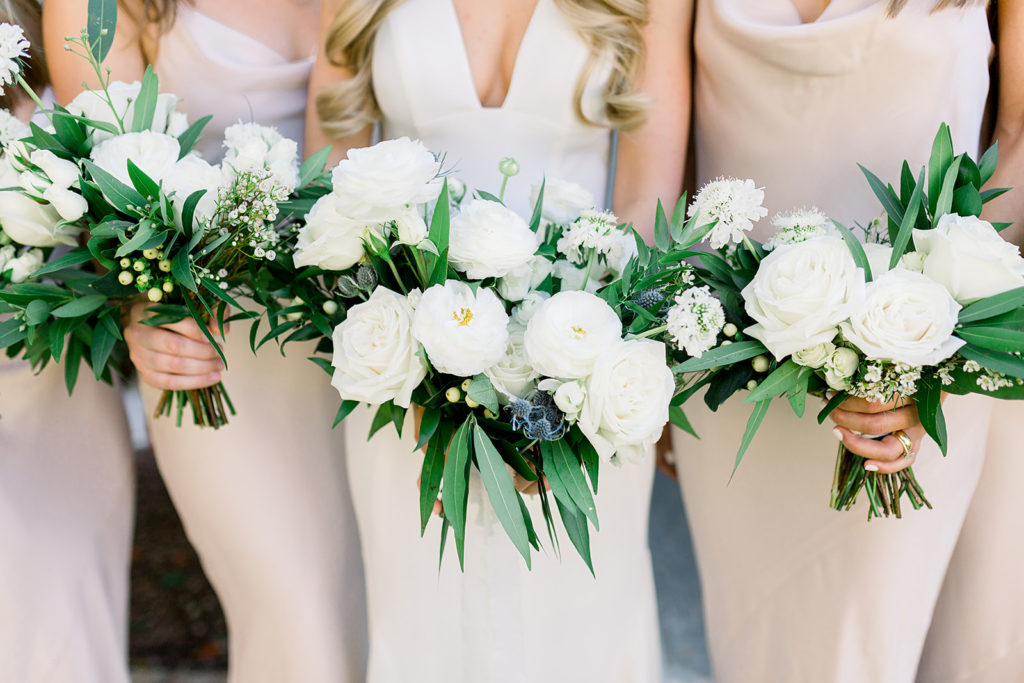 Bridesmaid bouquets and bridal bouquet at Arizona wedding Phoenix venue, Royal Palms. Stylish celebration featuring white wedding flowers and greenery with pillar candles featured in reception and ceremony. Floral arrangements by Array Design. Photography by Jessica Q.