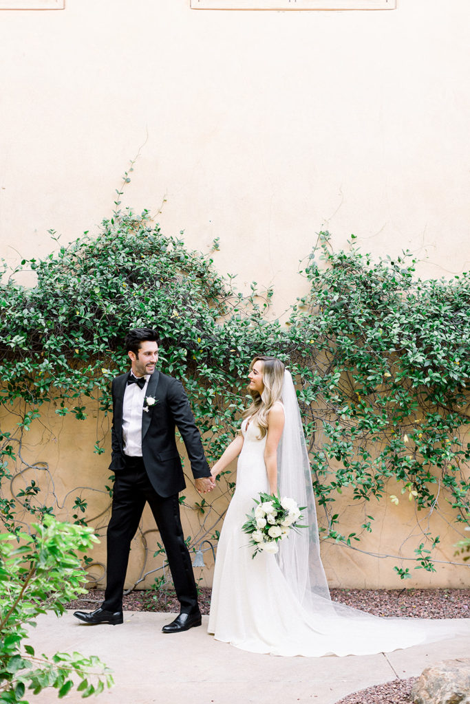 Arizona wedding Phoenix venue, Royal Palms. Stylish celebration featuring white wedding flowers and greenery with pillar candles featured in reception and ceremony. Floral arrangements by Array Design. Photography by Jessica Q.
