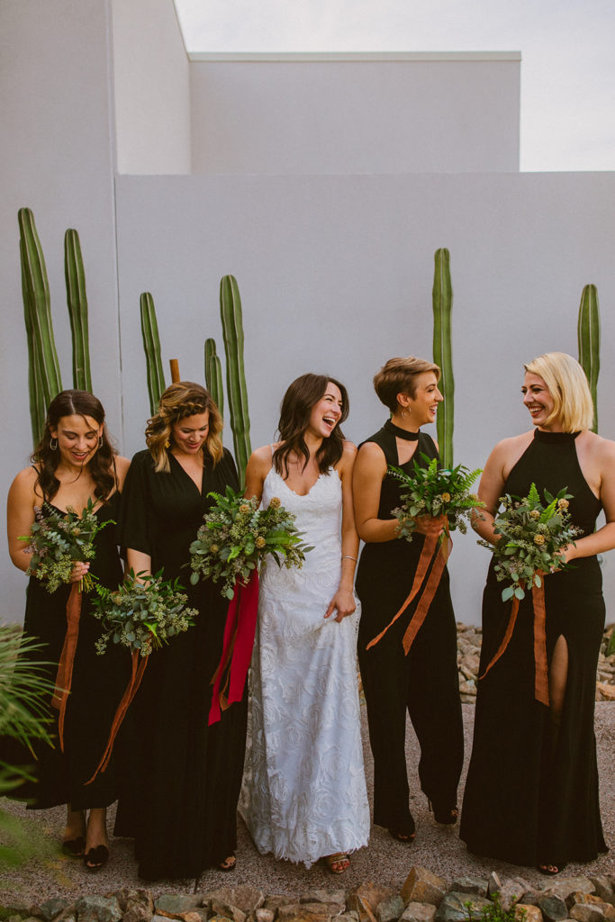 Paradise Valley Wedding - Unique greenery bouquets of bridal bouquet and bridesmaid bouquets at modern wedding and fall Arizona wedding. The greenery with warm colors wedding color palette was seen in the wedding flower arrangements, centerpieces, and arch flowers. Greenery bouquets, greenery boutonnières, and greenery with floral arrangements were also included. The fall wedding flower colors included a range of red, pink, orange, and peach, perfect to match the fall desert wedding sunset. Photos by Olivia Markle. #fallwedding #weddingbouquets #weddingflowers #weddings