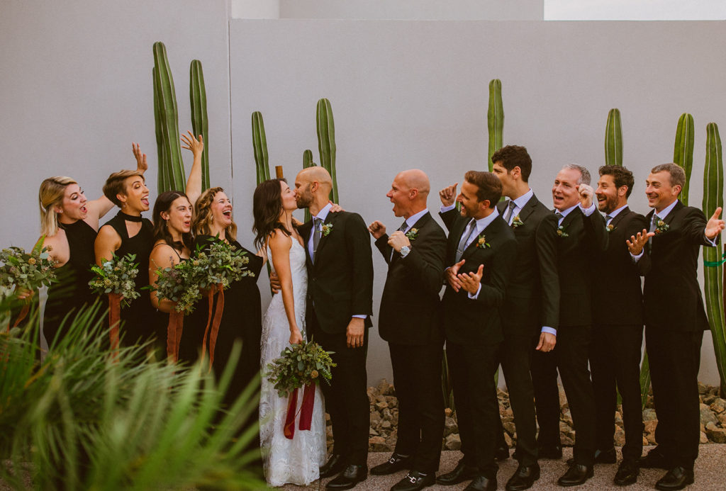 Paradise Valley Wedding - Bridal party at Mountain Shadows modern wedding and fall Arizona wedding. The greenery with warm colors wedding color palette was seen in the wedding flower arrangements, centerpieces, and arch flowers. Greenery bouquets, greenery boutonnières, and greenery with floral arrangements were also included. The fall wedding flower colors included a range of red, pink, orange, and peach, perfect to match the fall desert wedding sunset. Photos by Olivia Markle. #fallwedding #weddingbouquets #weddingflowers #weddings
