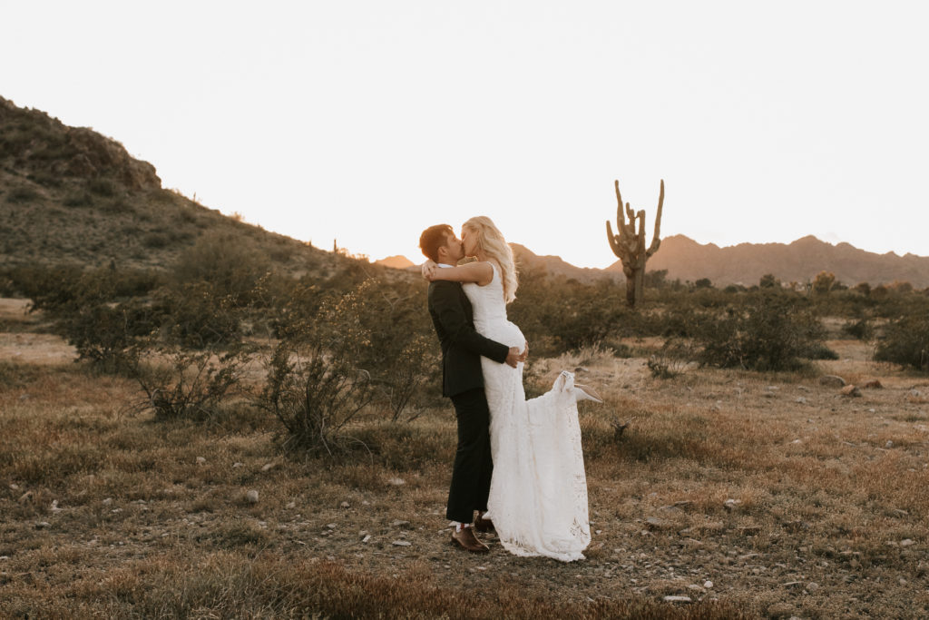 Boho Arizona Desert Ceremony - the perfect intimate boho desert wedding ceremony. The blush and white wedding flowers with dusty pink wedding color palette was seen in the wedding flower arrangements, ceremony decor, wedding bouquets, wedding ceremony backdrop outdoor, and wedding flowers. The boho wedding flowers included pampas grass, roses and greenery. Wedding ceremony altar of pampas grass, roses and greenery. Photos by Madi Robison. #weddingbouquets #desertwedding #weddingflowers #weddings