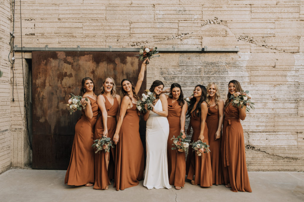 Full length image of bride and bridesmaids holding bouquets.