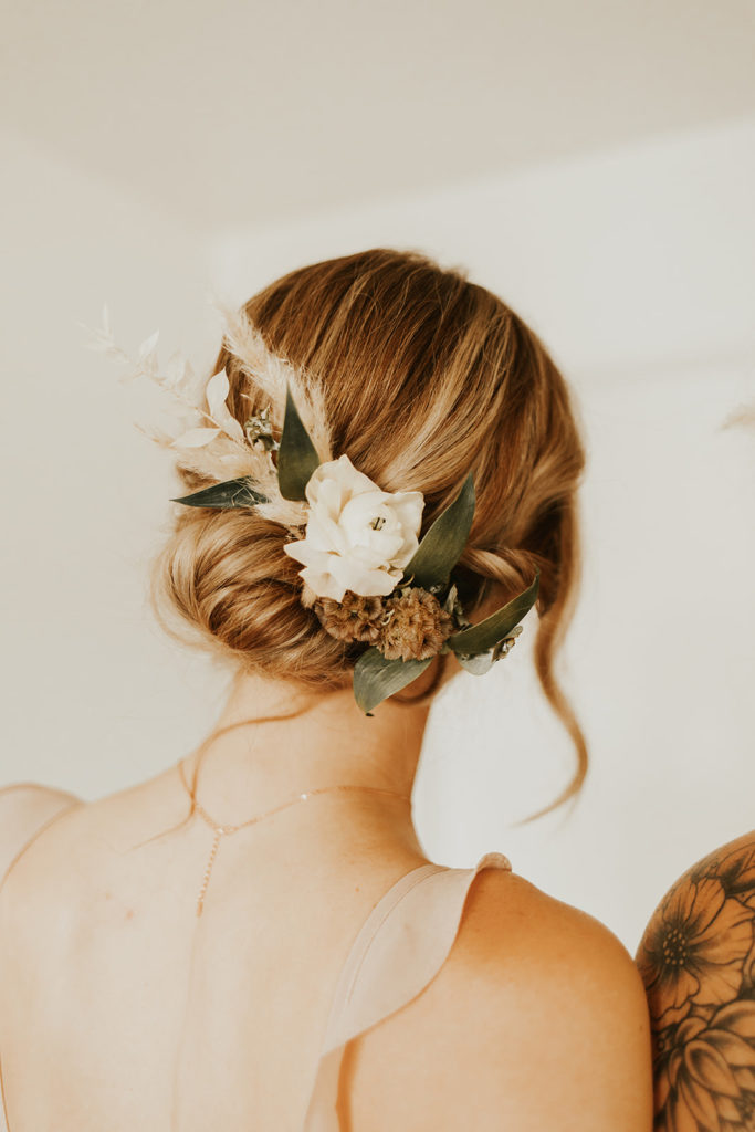 Bridesmaid hairpiece of white floral with pampas.