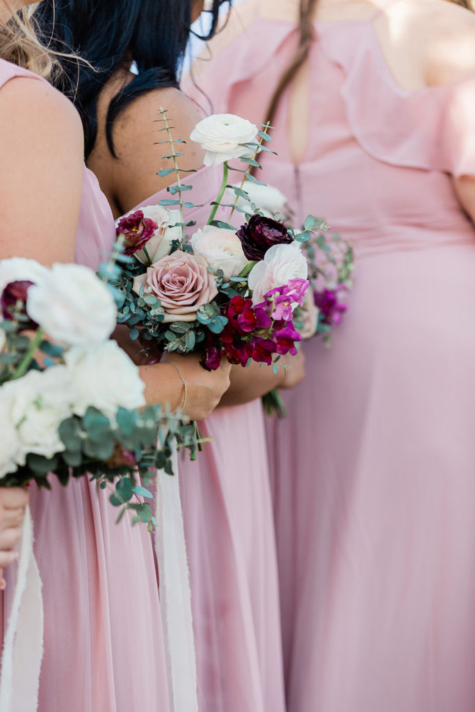 Bridesmaid bouquets of pink, blush, white, and fuchsia flowers.