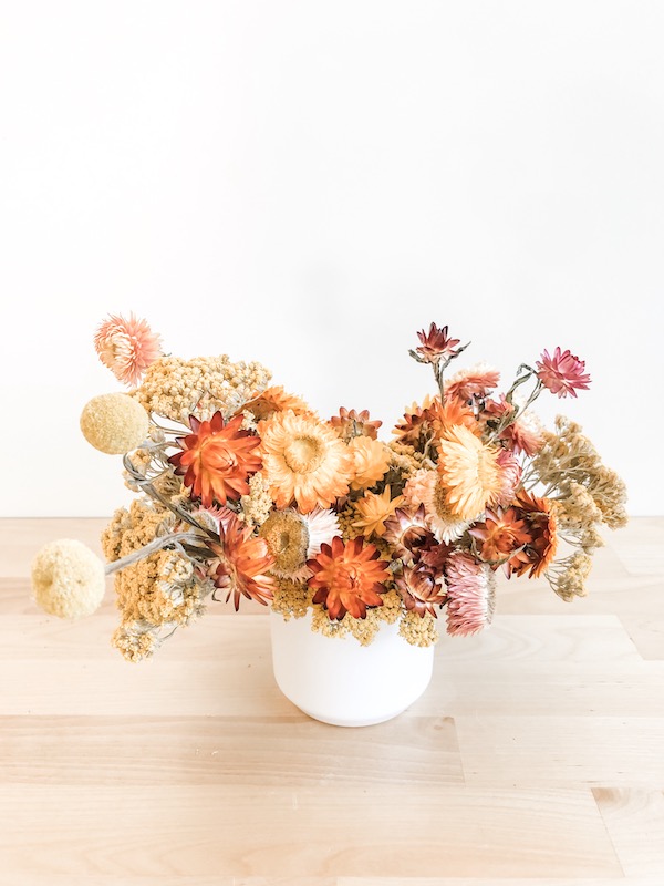 Bright yellow and red dried floral arrangement.