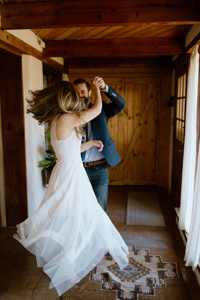 Bride and groom dancing in hallway.