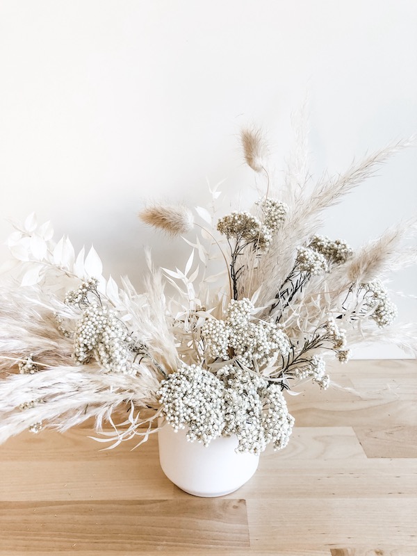 White dried floral and foliage arrangement.