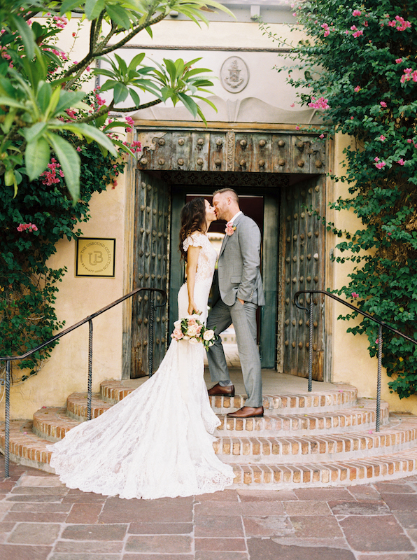 Bride and groom kissing on Royal Palms' steps.