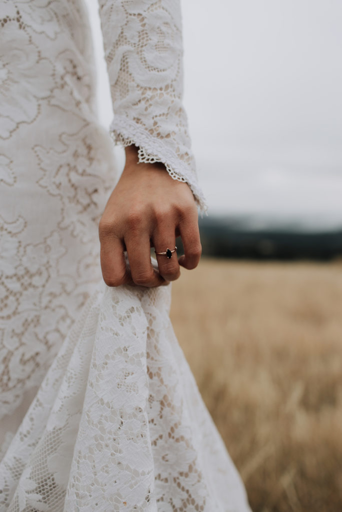 Wedding ring and wedding dress sleeve detail.