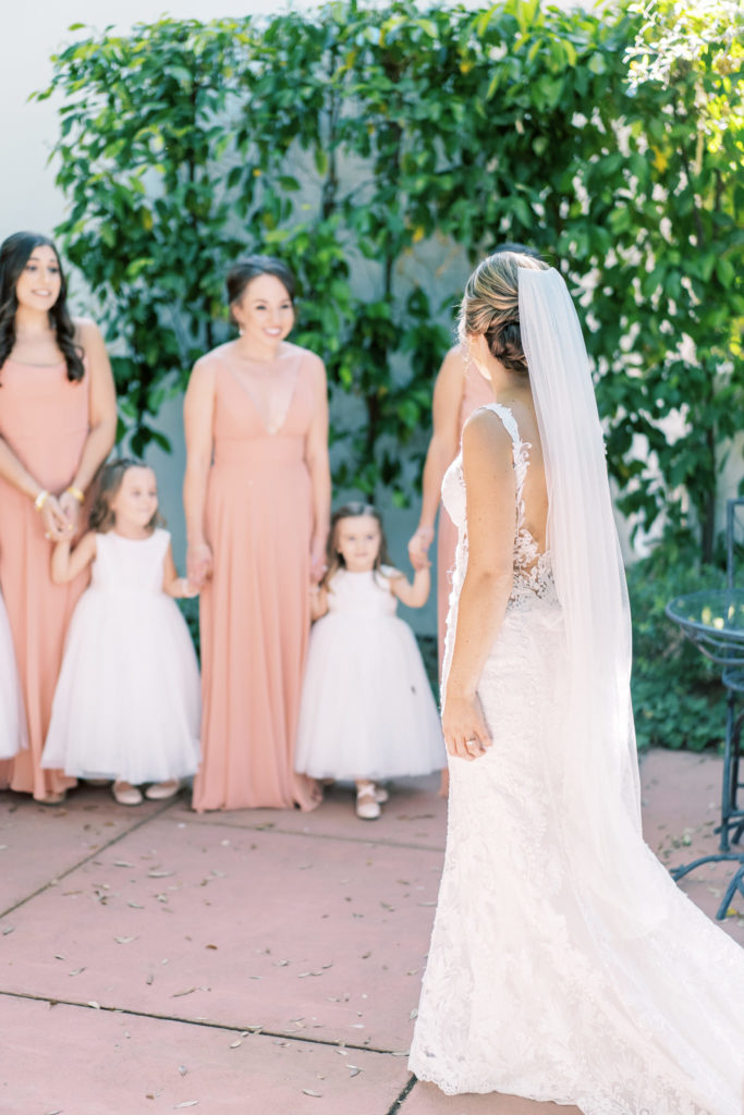 Bride having first look with bridesmaids and flower girls.