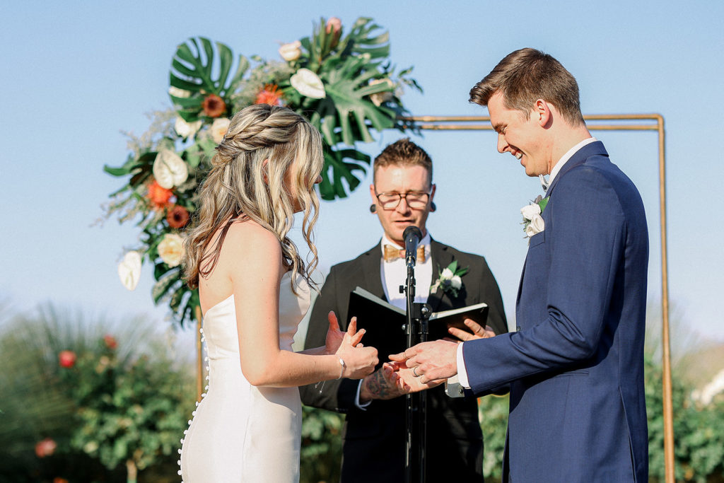 Wedding ceremony at Anthem Arizona with copper pipe arch with floral installation.