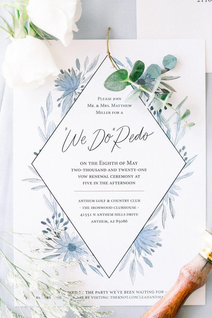 Wedding invitation of watercolor blue floral on white paper.