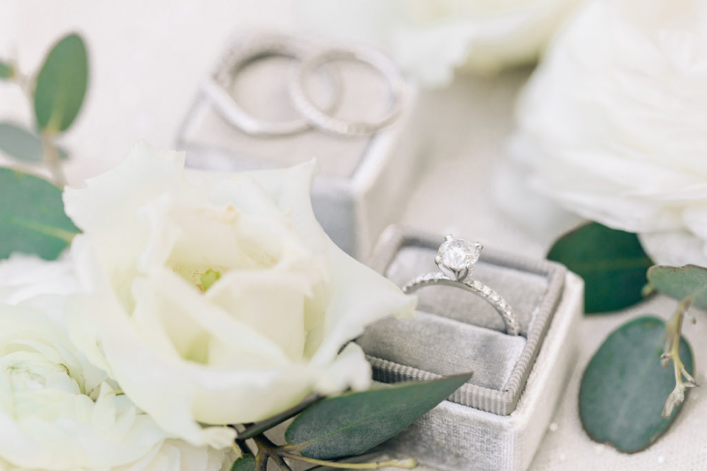 Wedding ring and white flower details.