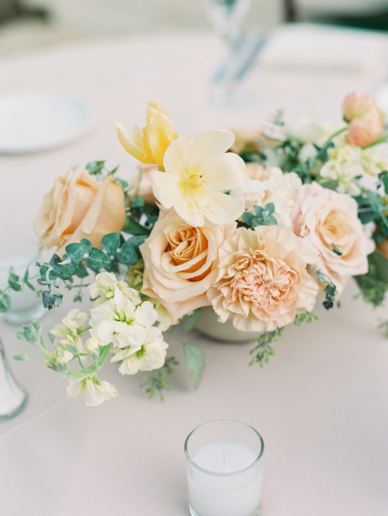 Pink and yellow floral with greenery centerpiece.