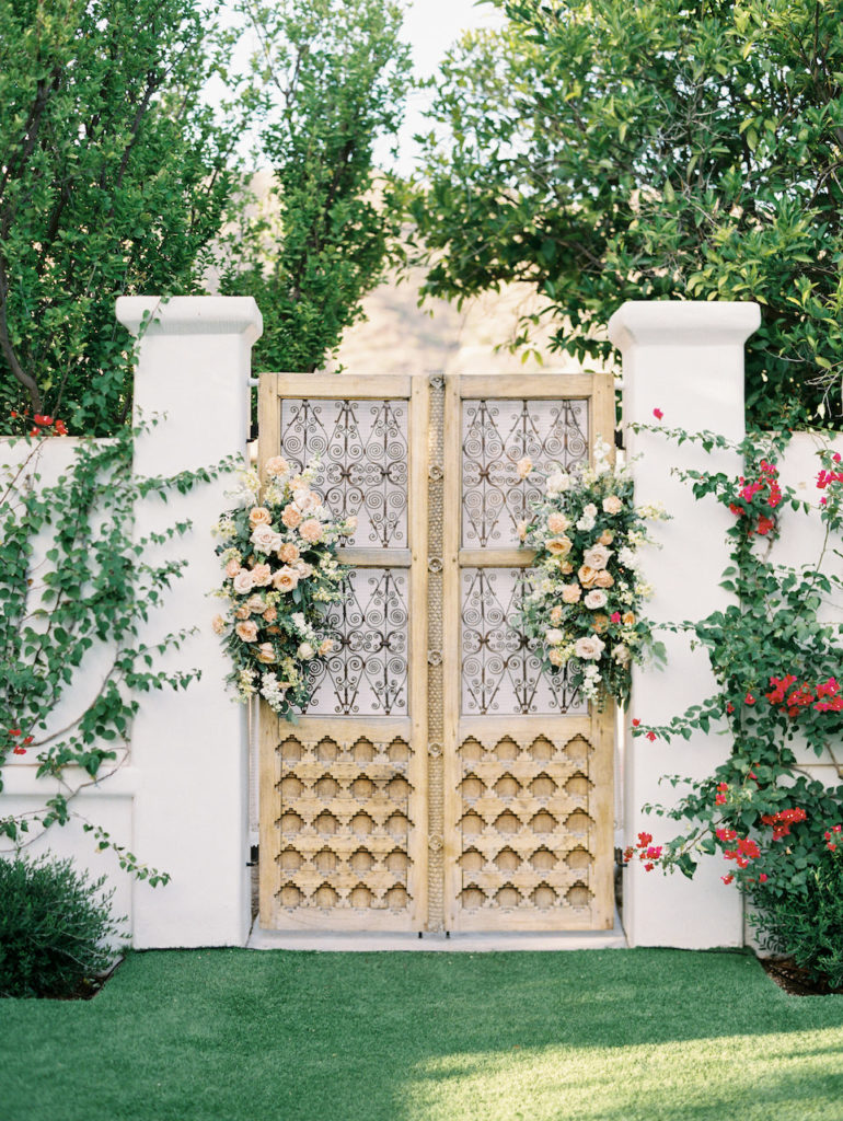 El Chorro wedding reception background doors with floral on both sides.