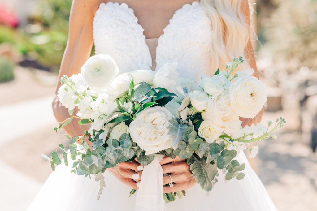 Bridal bouquet spring wedding white flowers and greenery.