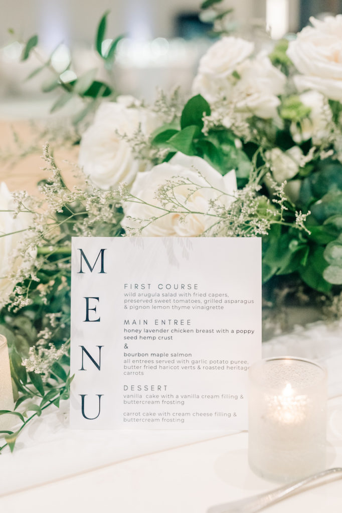 Wedding menu, white wedding flowers and greenery, tea light.