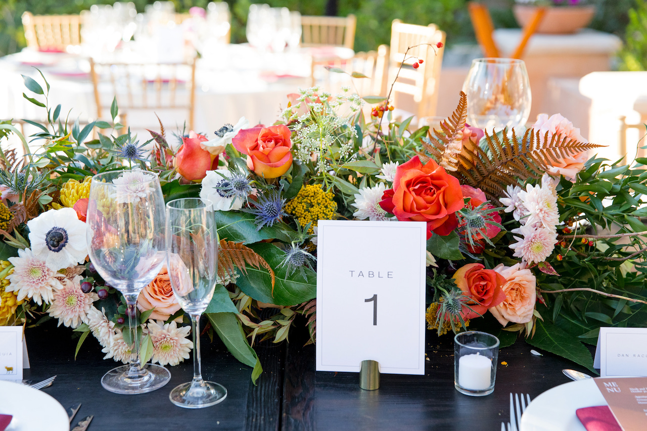 Table number and centerpiece at fall wedding reception.