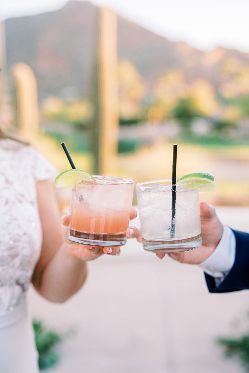 Toasting two drinks in class cups at wedding.