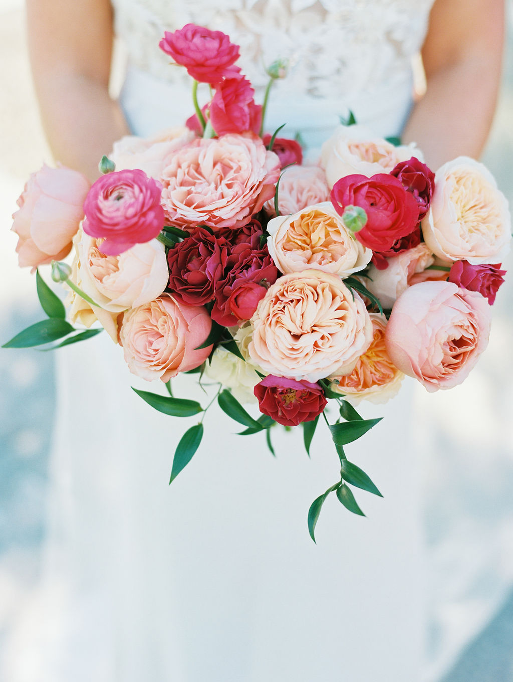 Rose and ranunculus bouquet of pink and peach colors for bride.