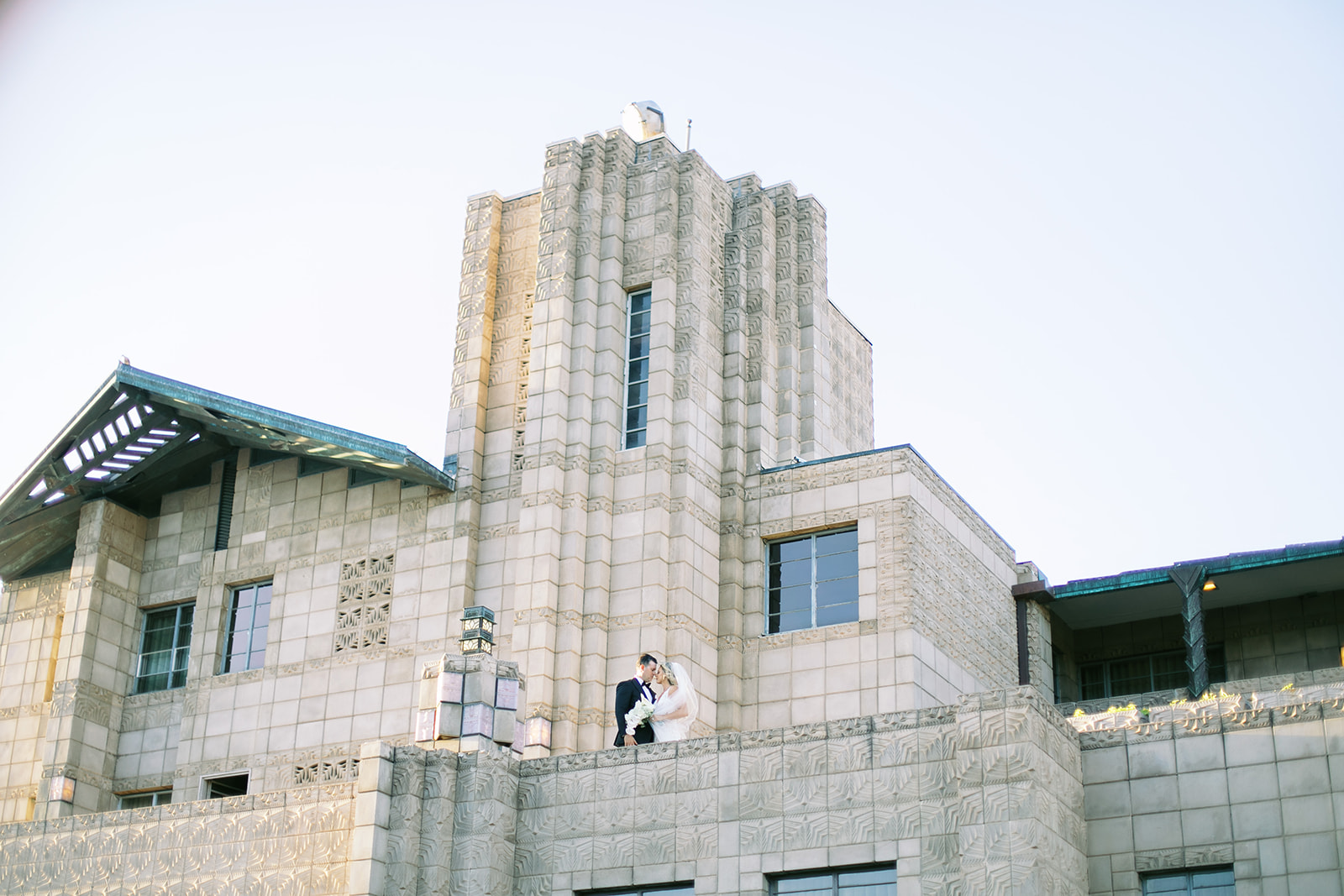Bride and groom embracing on a outdoor landing of the Arizona Biltmore.