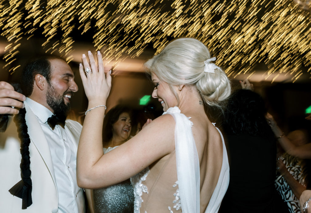 Bride and groom dancing at wedding reception.