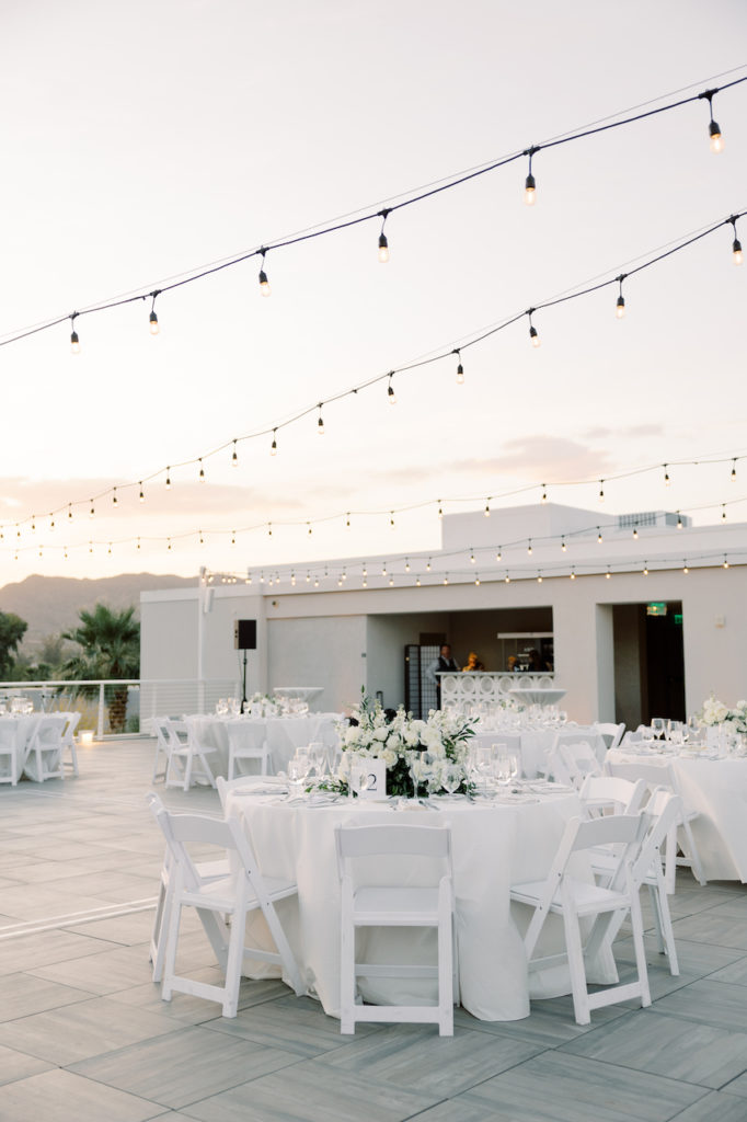 Mountain Shadows outdoor patio with round reception tables of white linen and white chairs.