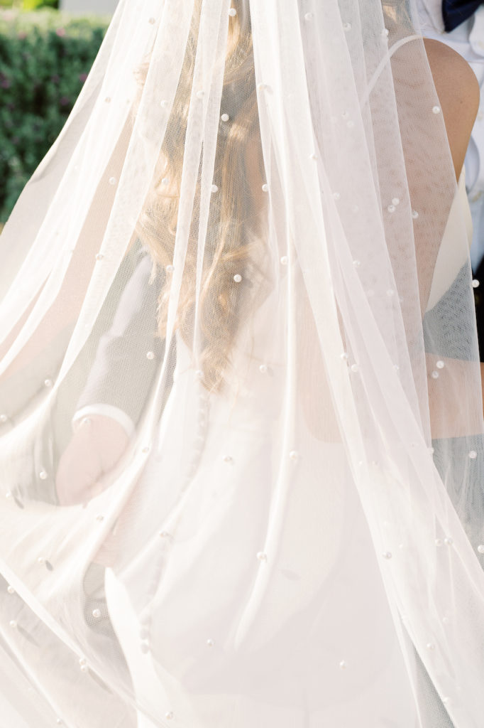 Bride's sheer train with pearl embellishments.