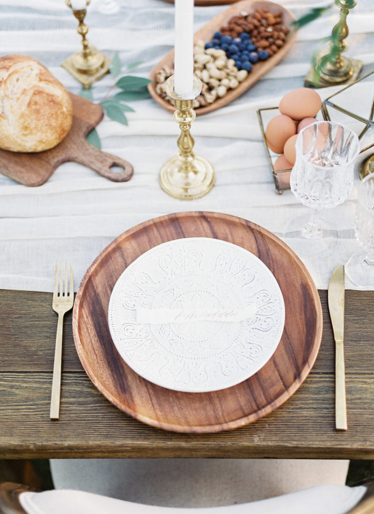 White plate with wood charger on set reception table.
