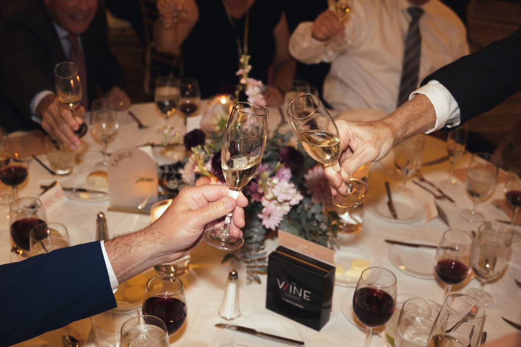 Wedding champagne toast during reception by guests.
