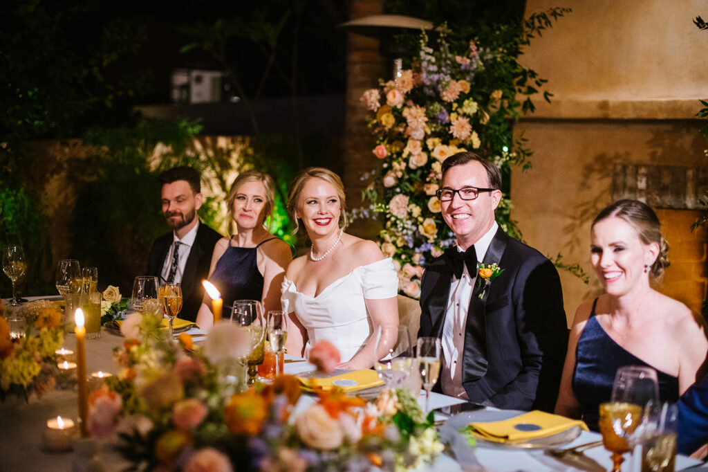 Bride and Groom at head table with wedding party during reception at Royal Palms.