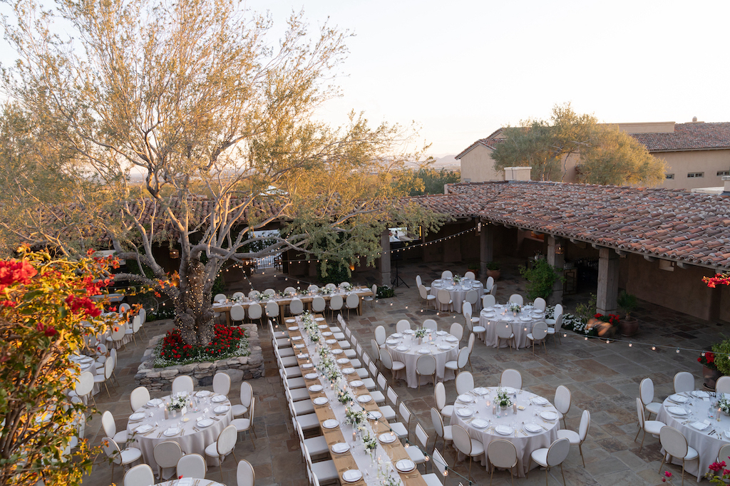 Overhead view of DC Ranch wedding reception space with long renter rectangular table and white round tables.