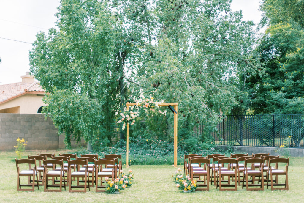 Outdoor ceremony space at The Caroline with arch at front.