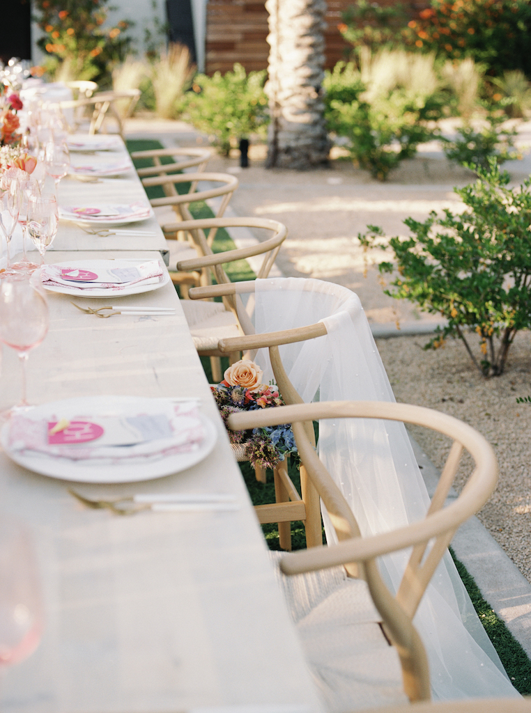 Long wedding reception tables at outdoor wedding reception.