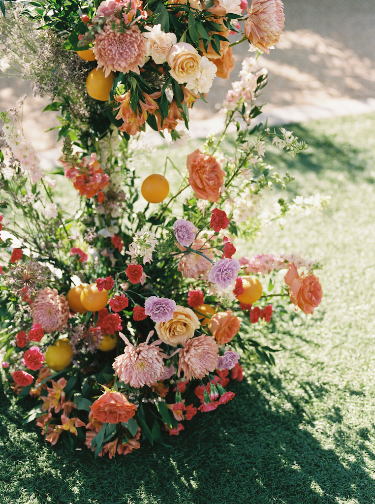 Wedding ceremony arch floral with citrus accents.