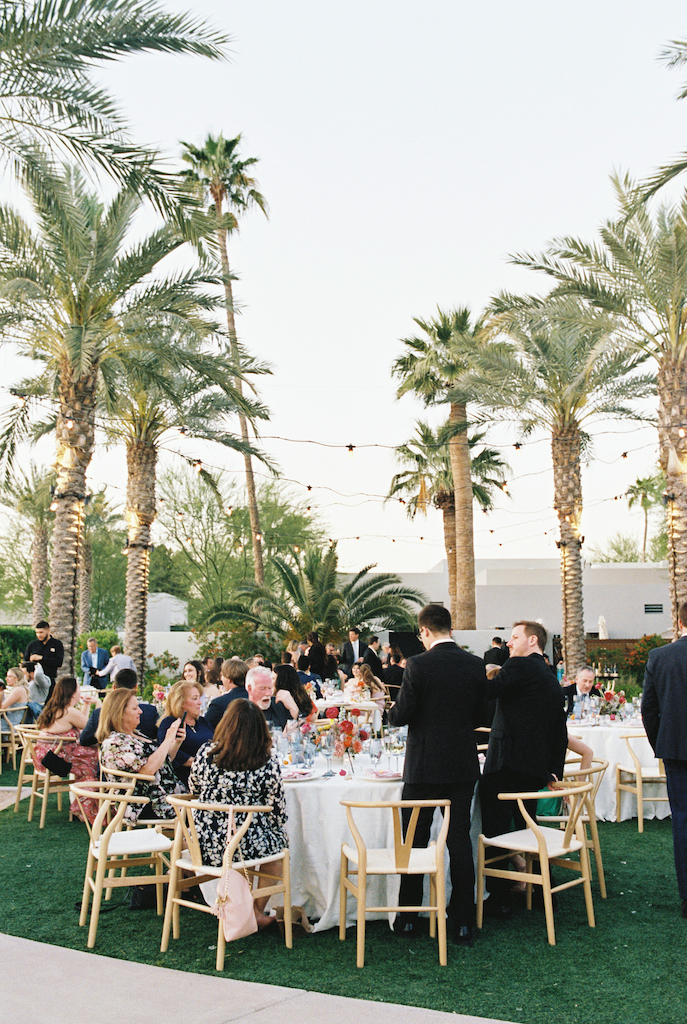 Outdoor wedding reception at Andaz Scottsdale with round reception tables and palm trees.