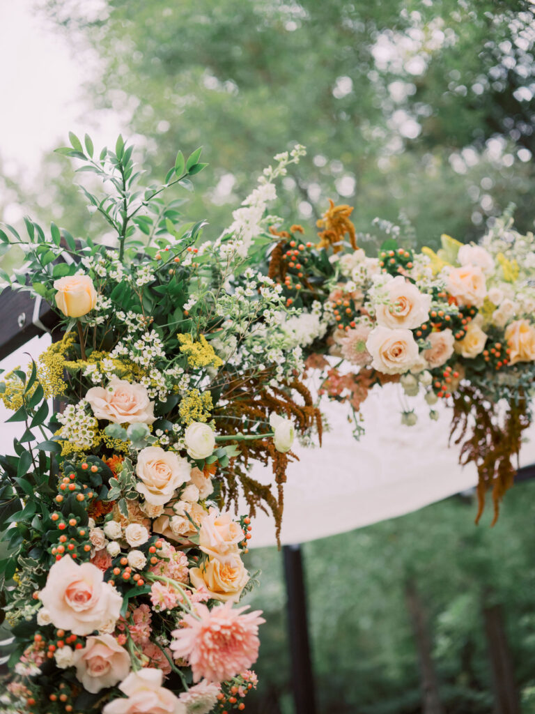 Floral installation on wedding arch.