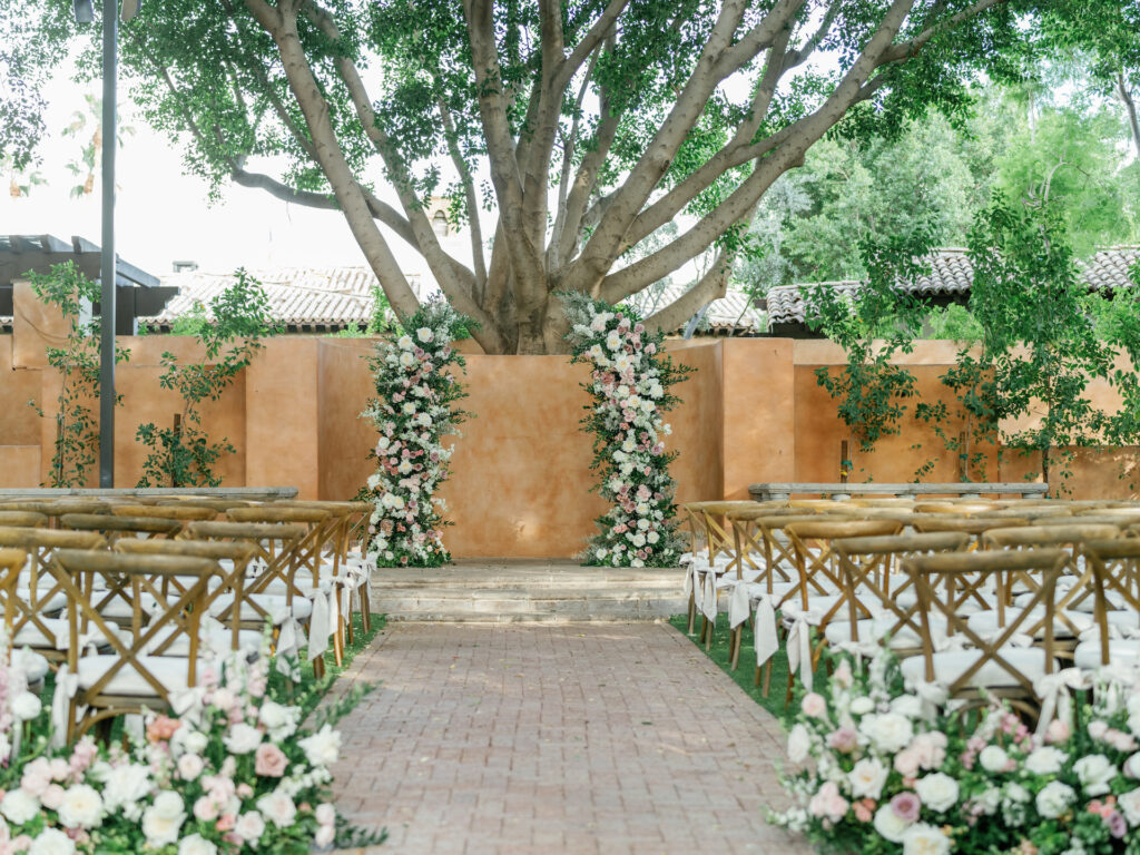 Wedding ceremony space at Royal Palms with floral columns and aisle floral.