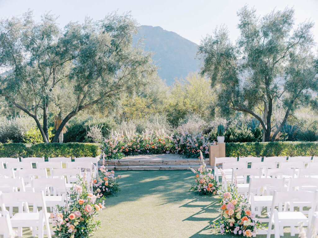 El Chorro Wedding ceremony space with ground floral arc at front and aisle arrangements.