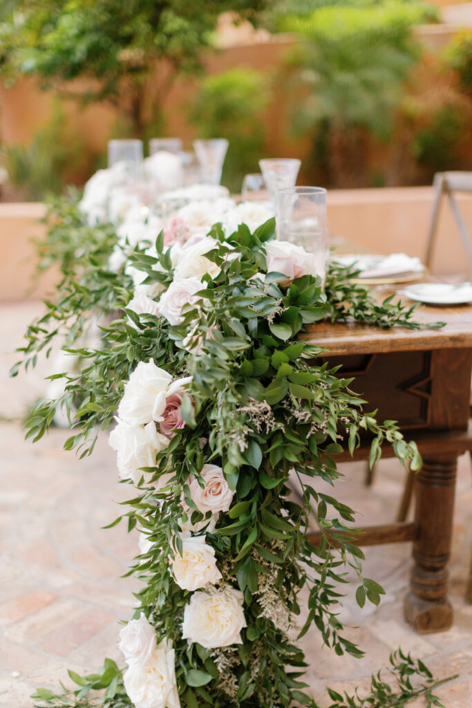 Reception table floral and greenery garland.