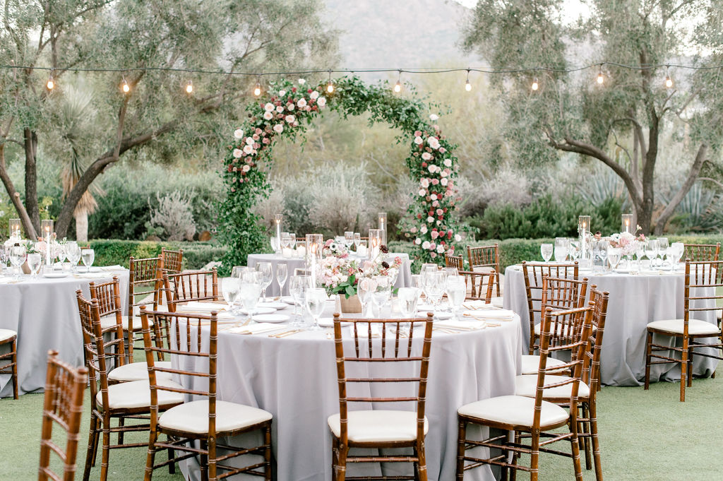 Outdoor wedding reception space with round tables.