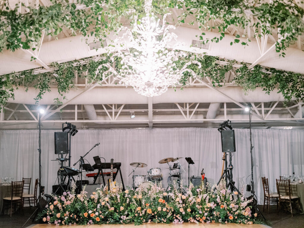 El Chorro indoor reception space with hanging floor greenery and band space with dance floor.